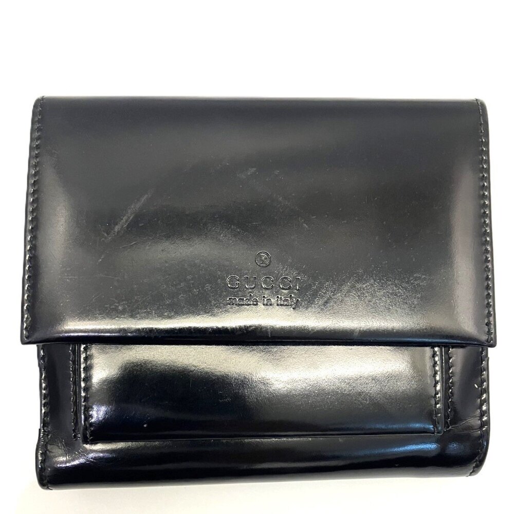 Gucci bi-fold wallet, enamel leather, black, embossed.